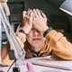 Stressed-out young woman sits at desk